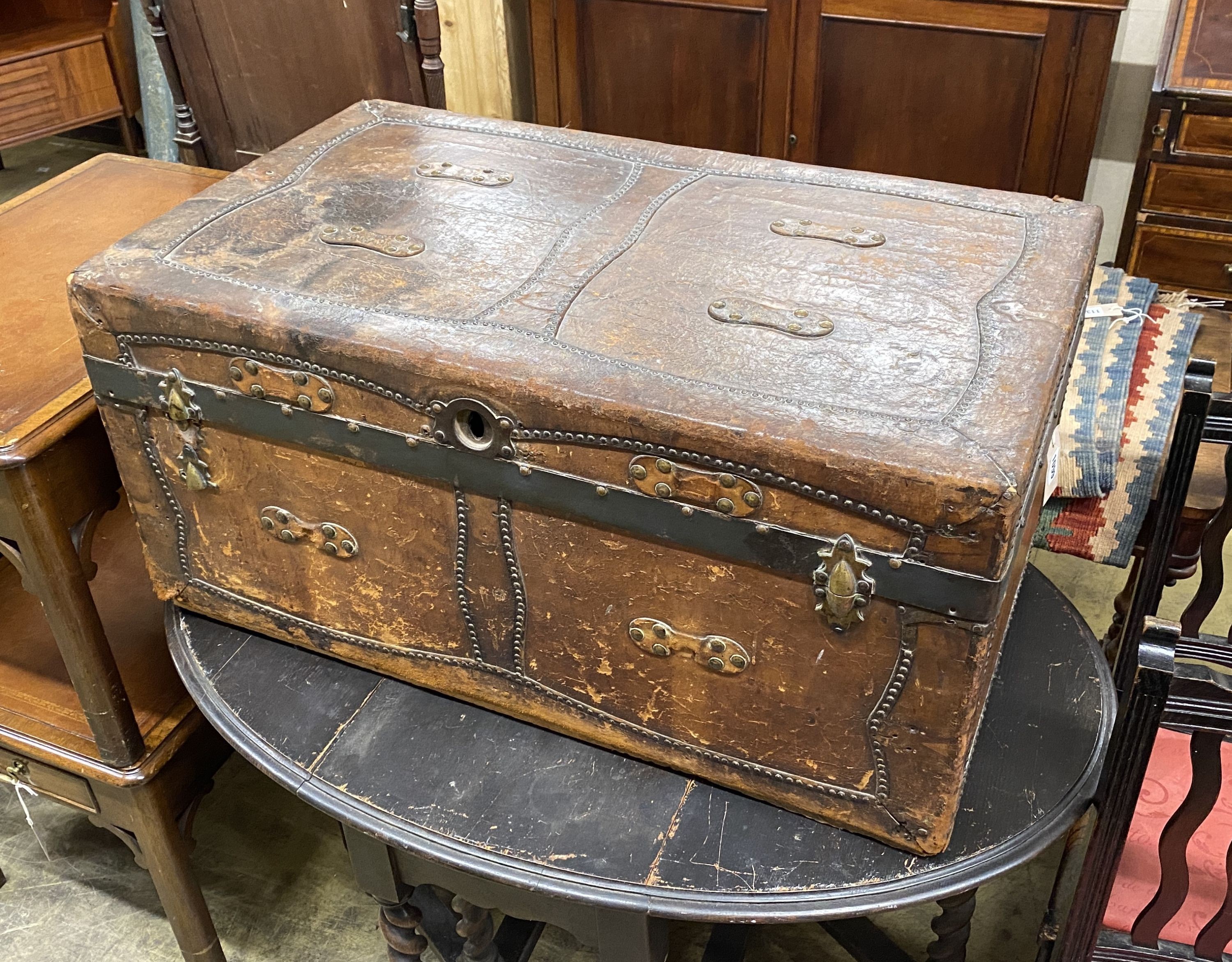 A 19th century studded brown leather covered trunk, length 87cm, depth 51cm, height 41cm